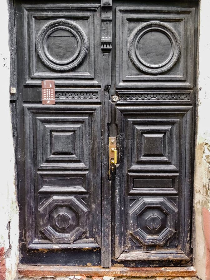 ancient wooden black doors with infill and door handle stock photo ancient wooden black doors with infill and door handle stock photo