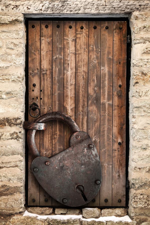 Ancient wooden door and big rusted lock