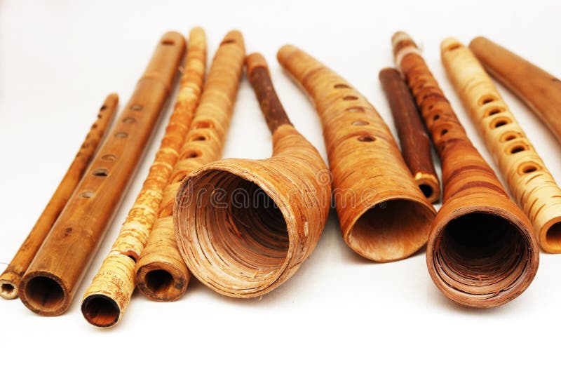 Ancient woodwind folk instruments on a white