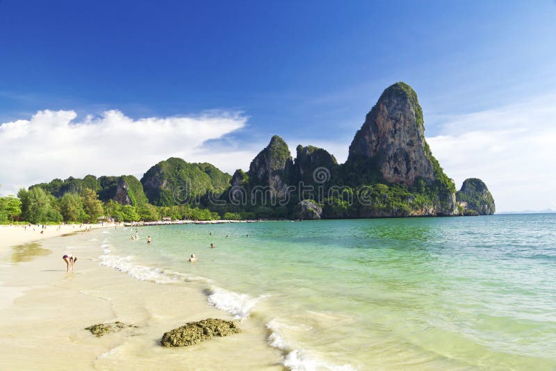 Beautiful tropical paradise Thailand island sea beach bay in the ocean and cliff mountain with cloudy day sky landscape background