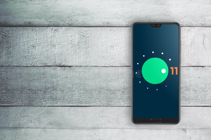 Android 11 operating system logo on a mobile phone screen. Top view and empty copy space stock image