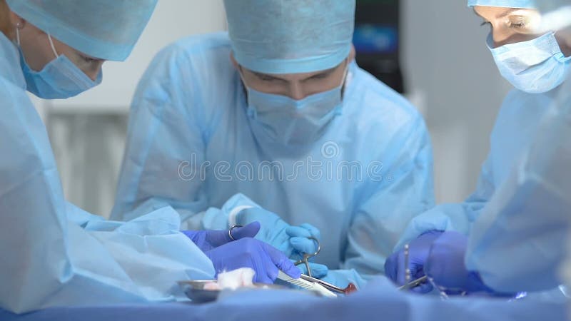 Anesthesia drip and qualified surgeons operating patient hospital, surgical team