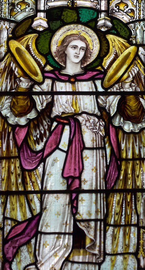 Detail of victorian stained glass church window in Fringford depicting a typical victorian angel with cymbals in his hands. Detail of victorian stained glass church window in Fringford depicting a typical victorian angel with cymbals in his hands