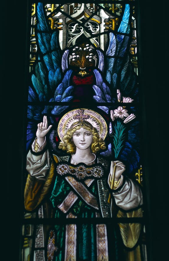 Detail of victorian stained glass church window in Fringford depicting a typical victorian angel with a lily in his hands. Detail of victorian stained glass church window in Fringford depicting a typical victorian angel with a lily in his hands