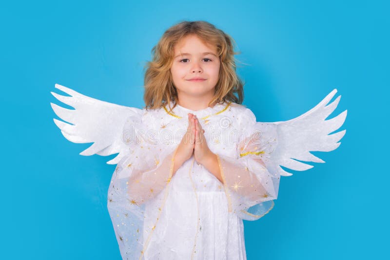 Angel child with prayer hands, hope and pray concept. Isolated studio shot. Cute kid with angel wings. Cupid, valentines royalty free stock images