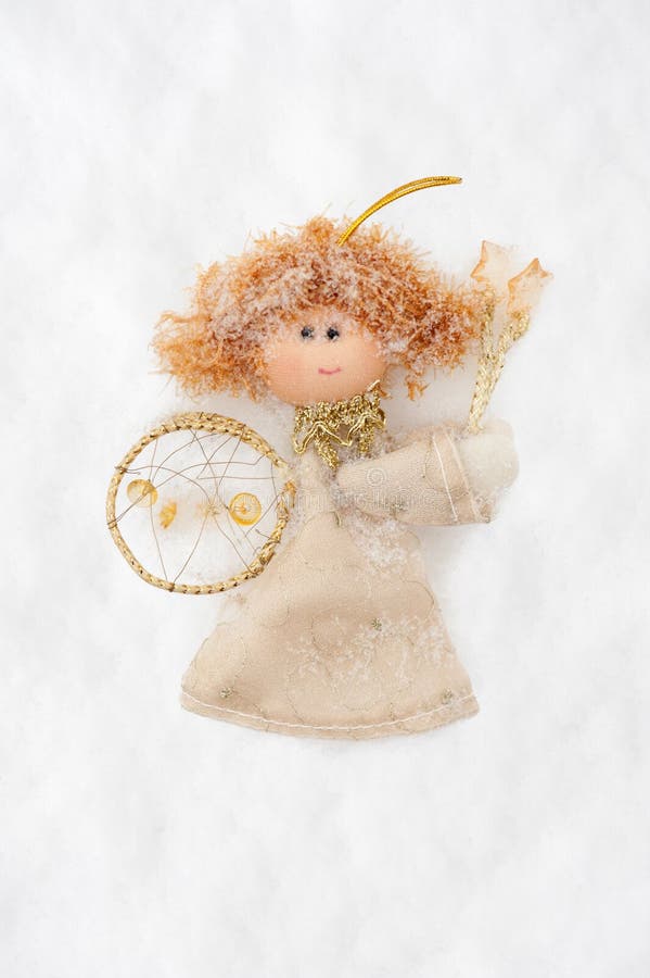 Angel doll made from fabric on snow