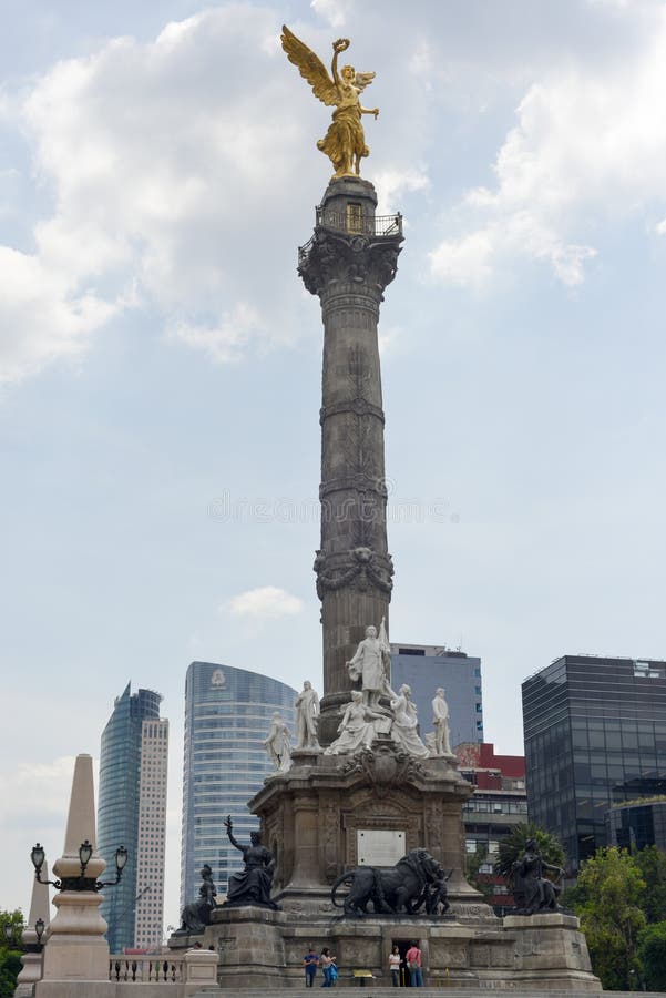 Mexico City, Mexico - July 3, 2013: Tourists around The Angel of Independence Victory column over Paseo de la Reforma in downtown Mexico City, Mexico. Mexico City, Mexico - July 3, 2013: Tourists around The Angel of Independence Victory column over Paseo de la Reforma in downtown Mexico City, Mexico.