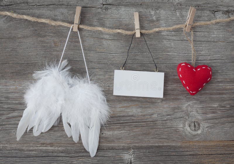Angel wings with heart and blank note royalty free stock photography Angel wings with heart and blank note royalty free stock photography