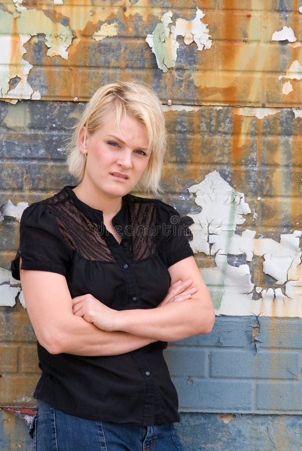 Young Caucasian woman staring with a disgusted look & crossed arms. Young Caucasian woman staring with a disgusted look & crossed arms.