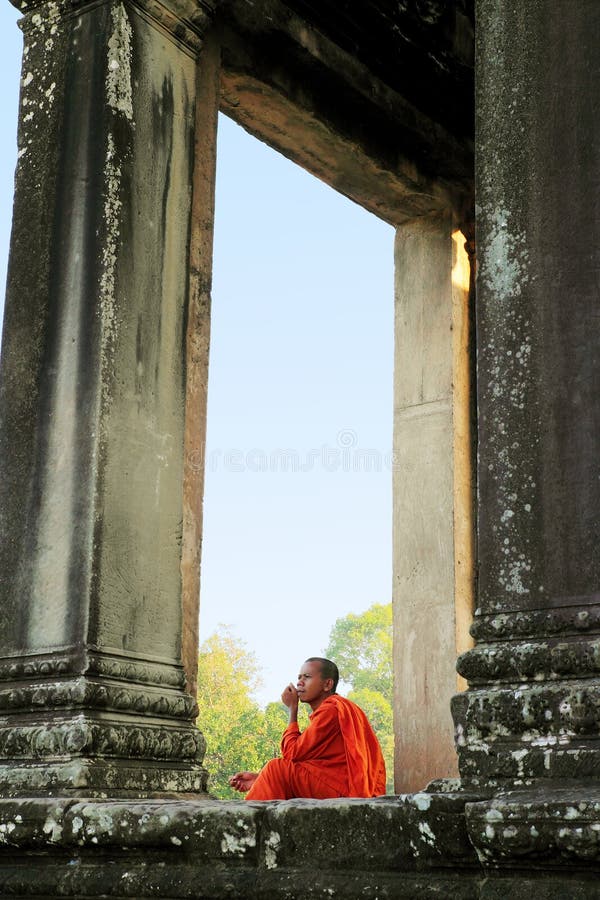 A monk sitting at the ancient Angkor Wat, Siem Reap, Cambodia. A monk sitting at the ancient Angkor Wat, Siem Reap, Cambodia.