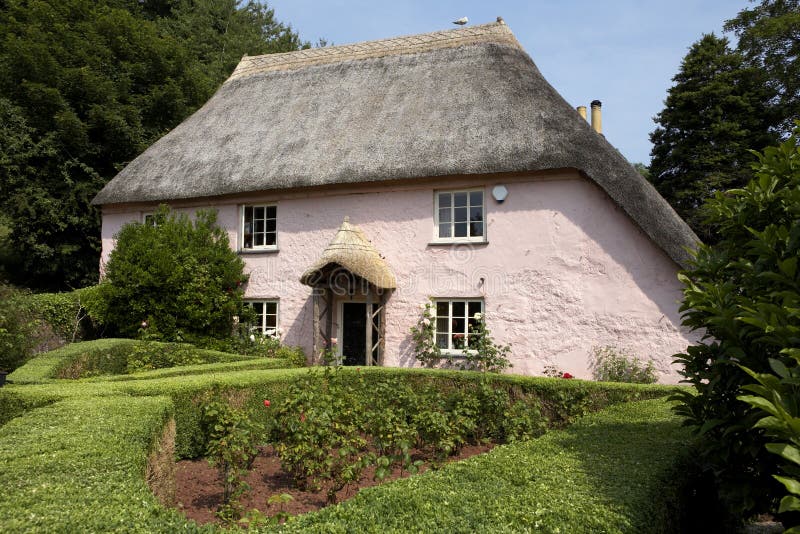 Traditional pink painted english cottage in the small village of cockington torquay torbay devon england europe uk taken in july 2006. Traditional pink painted english cottage in the small village of cockington torquay torbay devon england europe uk taken in july 2006