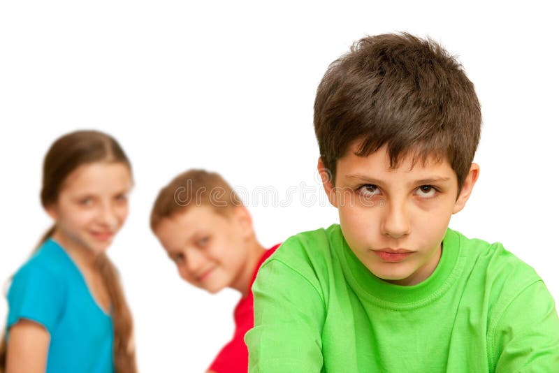 A boring kid is sitting against his happy friends; isolated on the white background. Boring kid white stock images, royalty-free photos and pictures