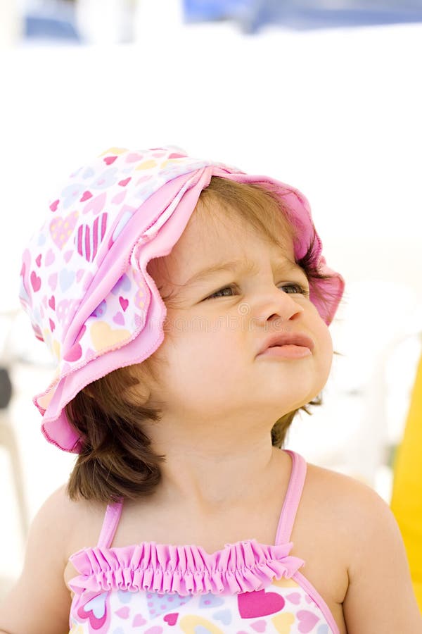 Angry baby girl at the beach