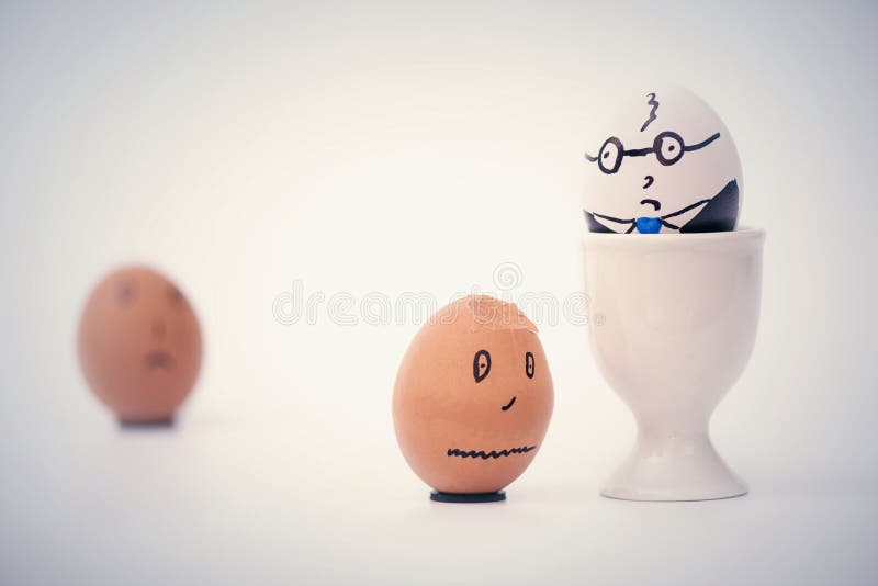 Angry boss and two employees in the form of white and dark eggs. royalty free stock photos Angry boss and two employees in the form of white and dark eggs. royalty free stock photos