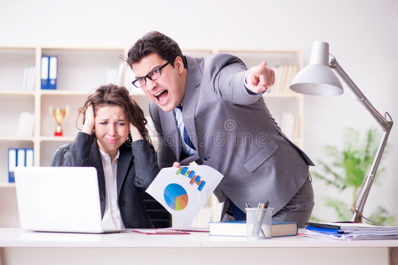 The angry boss unhappy with female employee performance royalty free stock photography