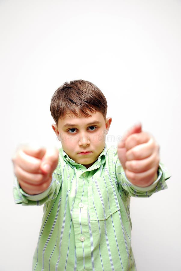 A young nine year old child with very angry face expression and two tight fists. If you use this photo, please tell me what you use it for, Its nice to see my photo in action! Site mail will be appreciated!. A young nine year old child with very angry face expression and two tight fists. If you use this photo, please tell me what you use it for, Its nice to see my photo in action! Site mail will be appreciated!