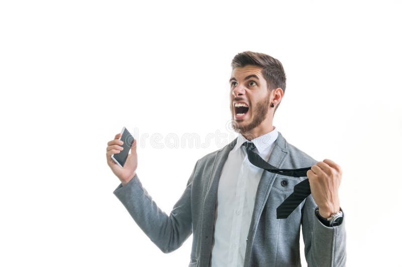 Angry business man with phone screaming isolated on white. Angry business man with phone screaming isolated on white