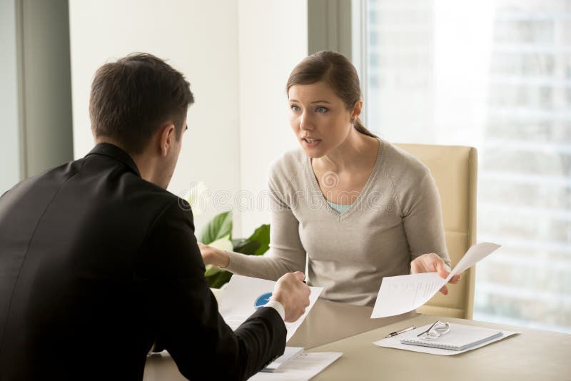 Angry businesswoman arguing with businessman about paperwork failure at workplace, executives having conflict over responsibility for bad work results, partners disputing about contract during meeting