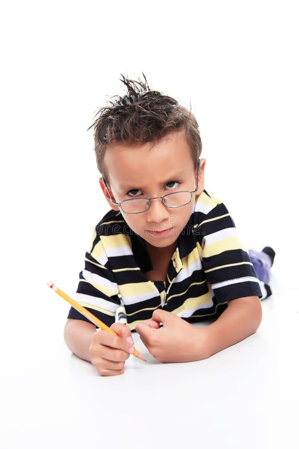 Child writing and looking at the camera, angry gestures. Child writing and looking at the camera, angry gestures