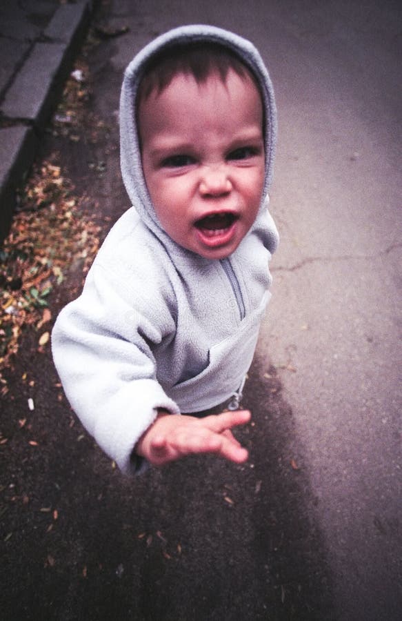 Angry child face, looking very mad; iso 400 film scan showing grain