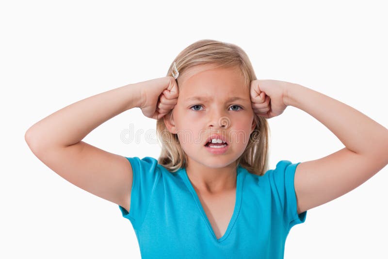 Angry girl with the fists on her face against a white background