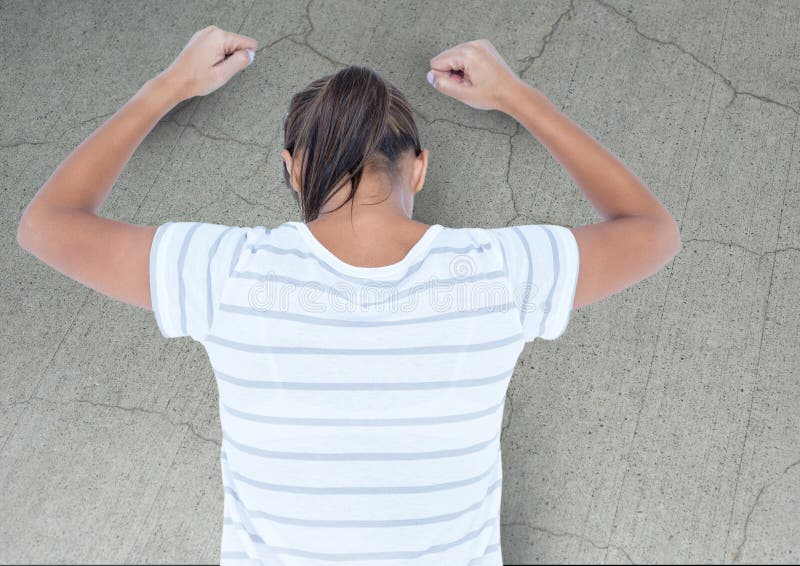 Digital composite of Angry grief struck young woman banging wall with cracks