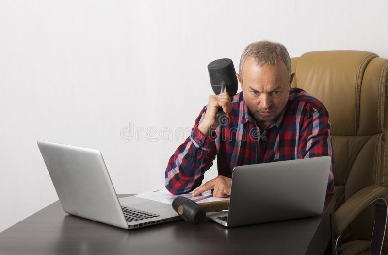 Angry man crashing laptop stock photo. Image of hammer 61071300