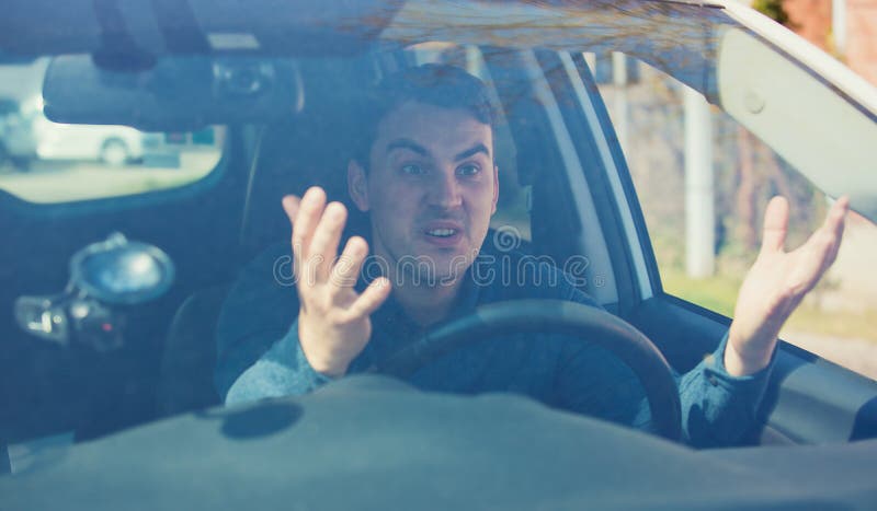 Angry Man Driving A Vehicle Arguing And Gesturing Shaking His Hands