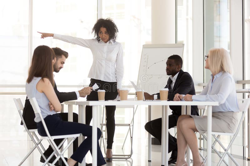 Angry mixed-race manager firing incompetent employee asking to l royalty free stock photography Angry mixed-race manager firing incompetent employee asking to l royalty free stock photography