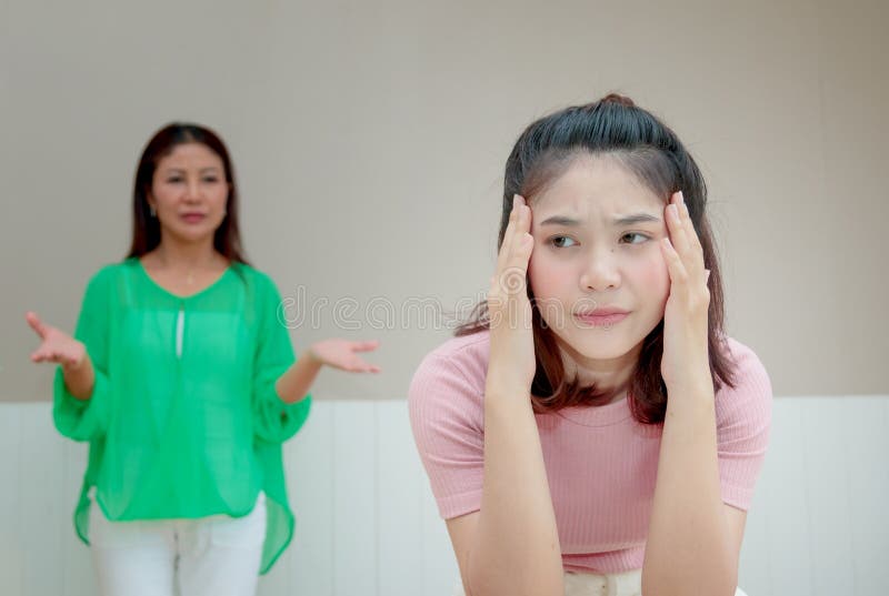 Angry mother stands behind her daughter complain something stock photos Angry mother stands behind her daughter complain something stock photos
