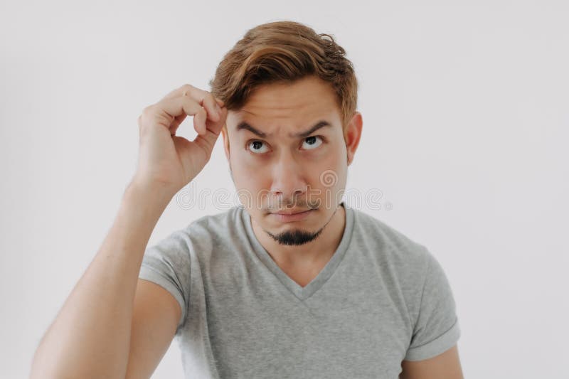 Angry and sad face man not impress with his hair color isolated on white.