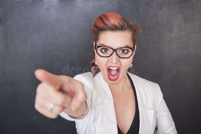 Angry screaming teacher pointing out on chalkboard background