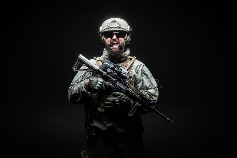 Male soldier in tactical equipment and uniform (coyote brown color) . Shot  in studio on a white background Stock Photo