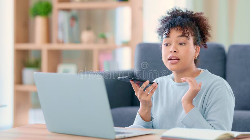 An angry student talking on the phone with a classmate while working on a project with her laptop at home. Young woman stock video footage