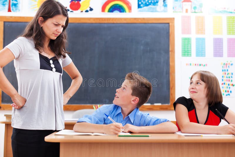Angry teacher looking at scared boy
