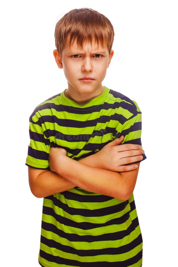 Angry teenage boy child feels anger blonde in a striped green shirt and jeans on white background