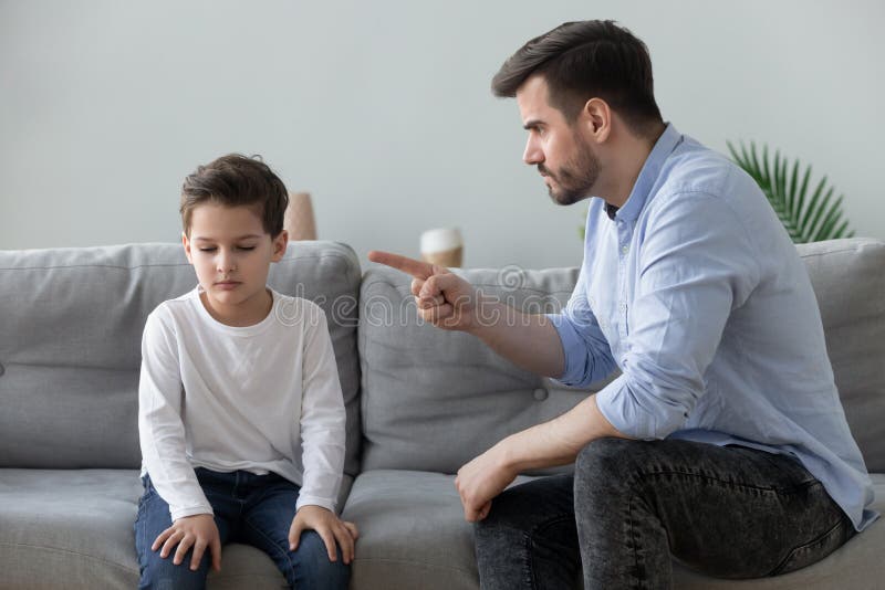 Angry mad father scolding lecturing sad preschool kid son for bad behavior at home, serious parent dad punish little upset guilty child boy pointing finger demand discipline, family conflicts concept. Angry mad father scolding lecturing sad preschool kid son for bad behavior at home, serious parent dad punish little upset guilty child boy pointing finger demand discipline, family conflicts concept