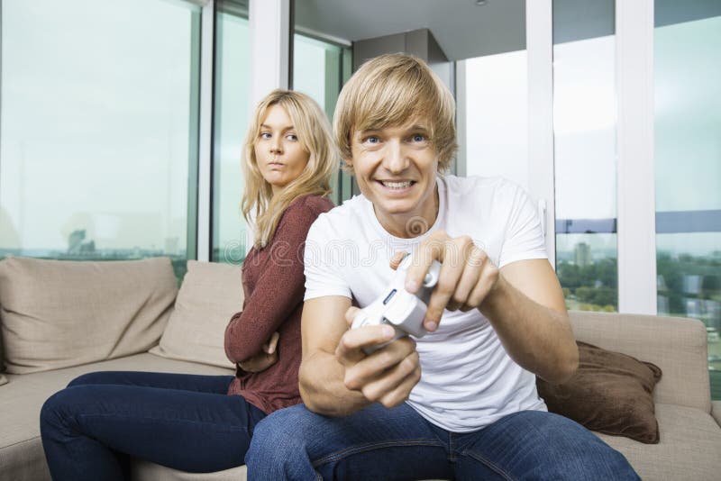 Angry Woman Looking At Man Play Video Game In Living Room At Home Stock Image Image Of