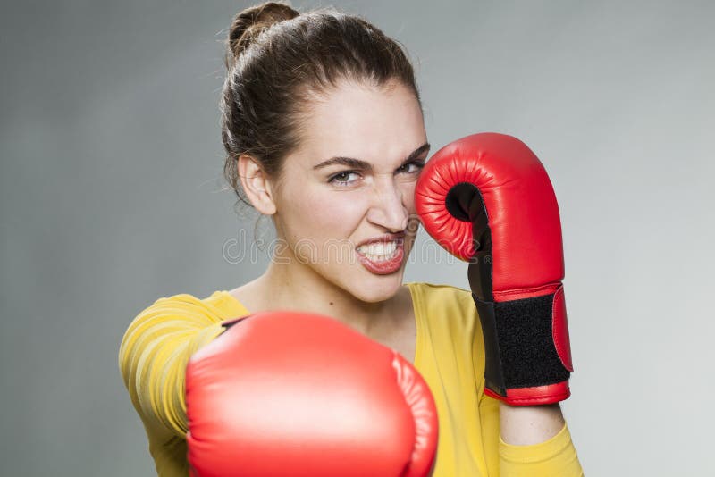 Angry young woman punching and blocking stock images Angry young woman punching and blocking stock images