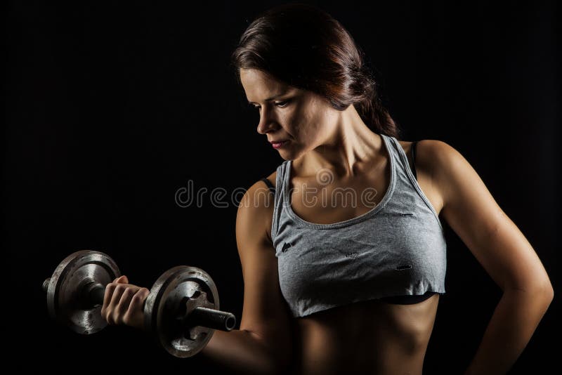 Young fitness woman working out with weights. Young fitness woman working out with weights