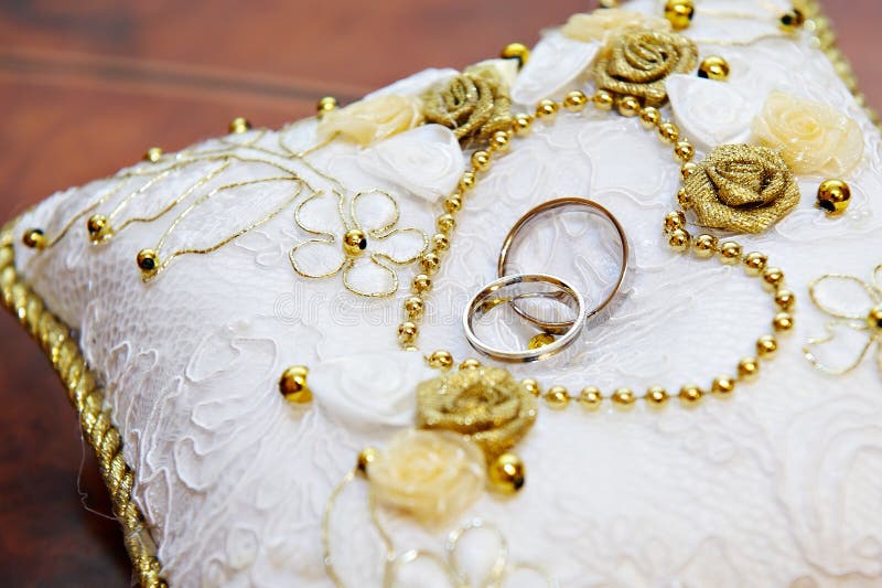 Gold wedding ring on a beautiful white pillow. Gold wedding ring on a beautiful white pillow