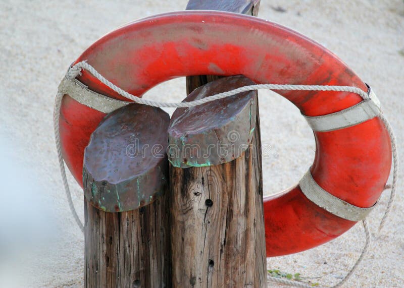 Life saver. donut ring buoy. Bright orange life saving ring on the beach with wooden piers. Lifeline. Rescue. Life saving buoy. Ship`s life ring. Bright orange donut ring buoy. Vintage life ring. Help. Life preserver vintage. Perry buoy. Copper topped piers on the beach with life saver ring. Abstract Safety. Security. Cruise liner life ring. Life saver. donut ring buoy. Bright orange life saving ring on the beach with wooden piers. Lifeline. Rescue. Life saving buoy. Ship`s life ring. Bright orange donut ring buoy. Vintage life ring. Help. Life preserver vintage. Perry buoy. Copper topped piers on the beach with life saver ring. Abstract Safety. Security. Cruise liner life ring.