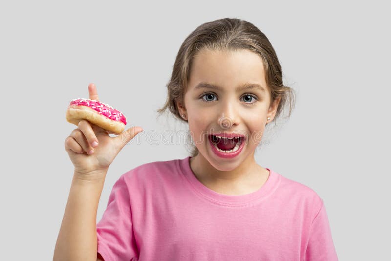 Studio portrait of a beautiful girl with a donut on her finger. Studio portrait of a beautiful girl with a donut on her finger