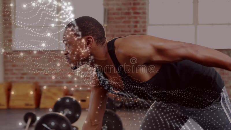 Animación de puntos brillantes sobre hombre fuerte haciendo ejercicio en el gimnasio metrajes