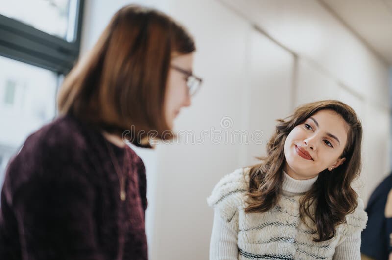 A group of coworkers collaborating and discussing ideas in a modern kitchen office, working towards success in a creative environment. A group of coworkers collaborating and discussing ideas in a modern kitchen office, working towards success in a creative environment.