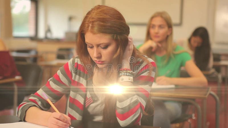 Animation of light over diverse female students writing in notebooks stock video footage