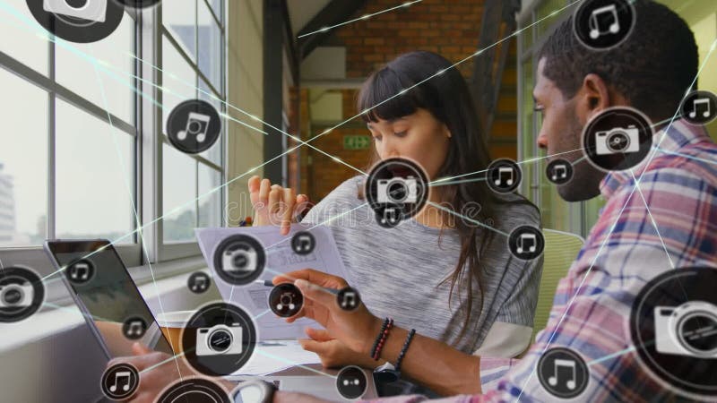 Animation of network of connections with icons over diverse business people in office stock video