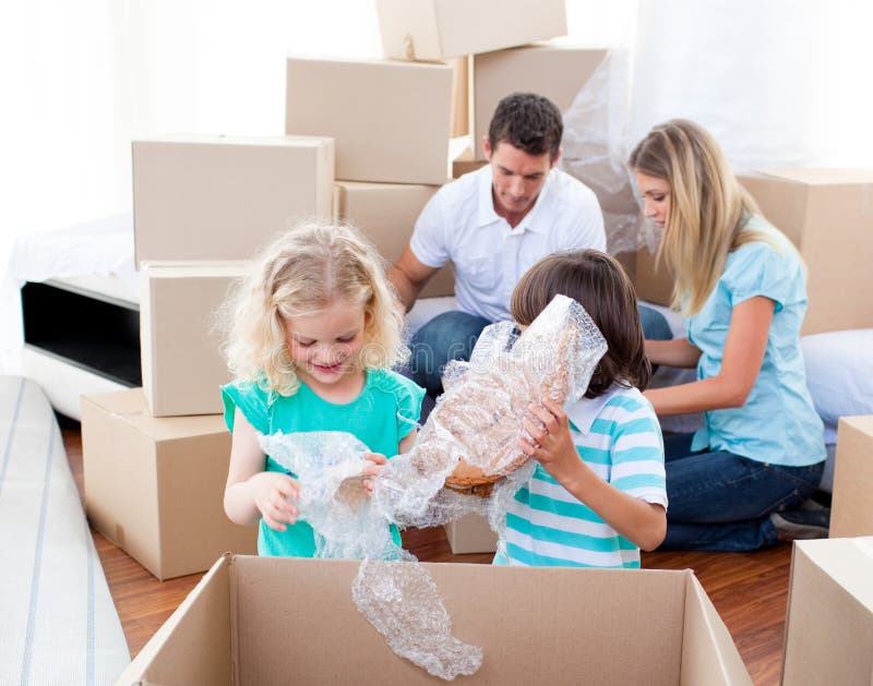 Animated family packing boxes while moving house. Animated family packing boxes while moving house