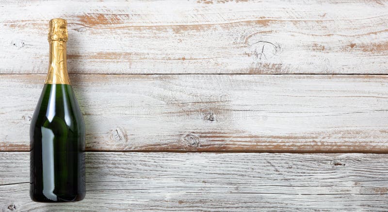 Anniversary background with a bottle of champagne on white weathered wood stock photography Anniversary background with a bottle of champagne on white weathered wood stock photography