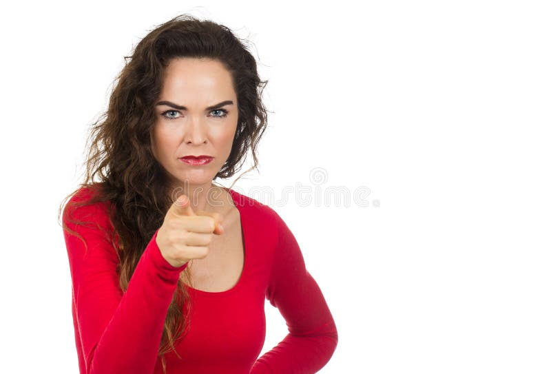 A very annoyed angry and irritated woman pointing towards camera. Isolated on white. A very annoyed angry and irritated woman pointing towards camera. Isolated on white.